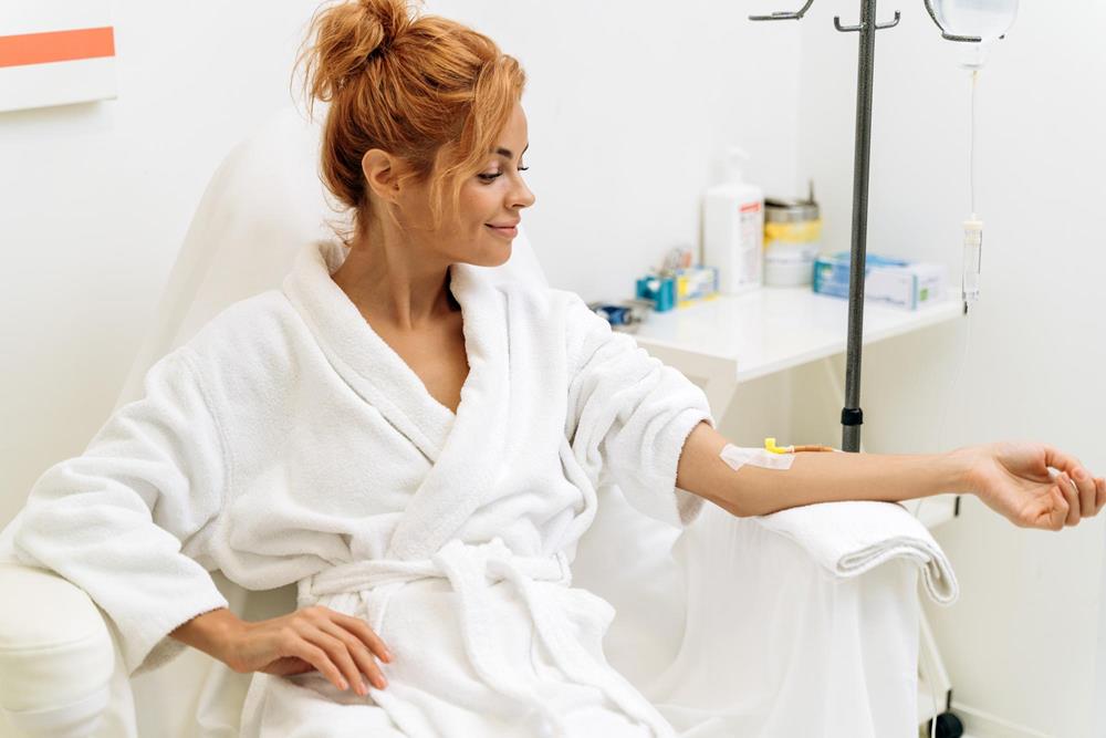 woman using an iv bag through injection on arm